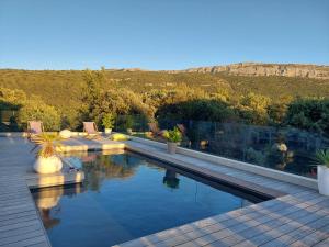 a swimming pool with a view of a mountain at Magnifique suite familiale in Nans-les-Pins