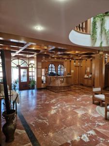 a large room with a lobby with a table at Hotel Rural Las Gacelas in Becerril de la Sierra