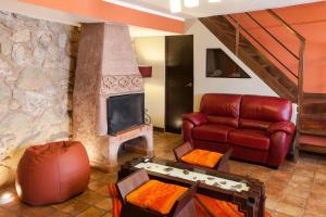 a living room with a couch and a fireplace at Quinua Boutique Apartments in Cusco