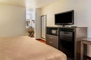 a hotel room with a bed and a flat screen tv at Quality Inn At Town Center in Beaufort