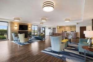 a living room with a couch and chairs and a table at Comfort Inn & Suites Victoria North in Victoria