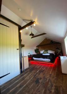 a bedroom with a bed in a attic at The Stable Annexe & Spa in Dogdyke