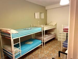 a room with three bunk beds in it at Cathedral Malaga Hostel in Málaga