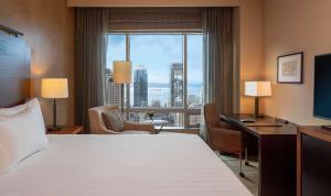 a hotel room with a bed and a desk and a window at Grand Hyatt Seattle in Seattle