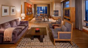 a living room with a couch and chairs and a table at Grand Hyatt Seattle in Seattle