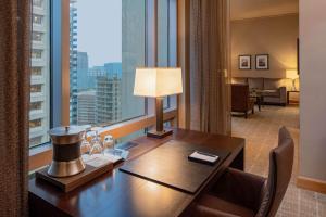 a hotel room with a desk and a large window at Grand Hyatt Seattle in Seattle
