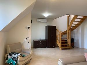 a living room with a couch and a staircase at Apartamenty Staromłyńska in Szczecin