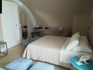 a bedroom with a bed and a table and a mirror at EUROPA Hotel in Vasto