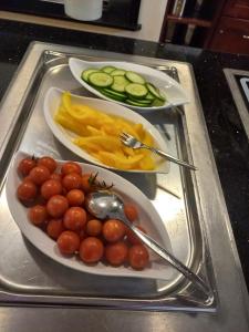 a tray with two plates of food with tomatoes and fruit at ANGERHOF Kur- und Thermenhotel in Bad Wörishofen