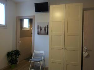 a room with a closet and a chair and a door at Dear Venice Bed & Breakfast in Marghera