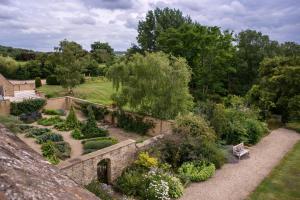 an aerial view of a garden with bushes and trees at Whatley Manor in Malmesbury