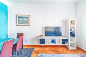 a living room with a table and a tv at JJ's Place in Trieste