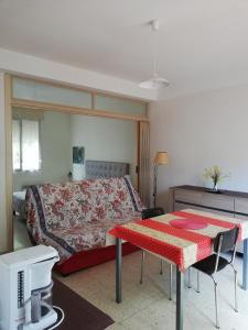 een slaapkamer met een bed en een tafel en een bed bij Chez Mi, centre ville, parking gratuit, arrivée autonome in Saint-Chinian