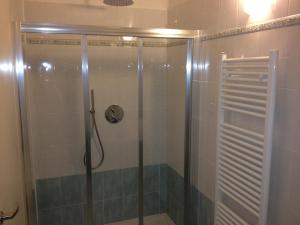 a shower with a glass door in a bathroom at B&B Teatro Ristori Verona in Verona