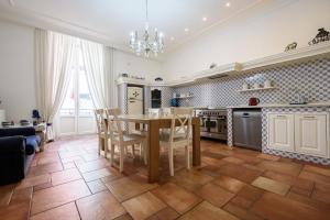 a kitchen with a table and chairs in a room at Palazzo dello Spagnolo Suite in Naples