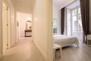 a bedroom with a bed and a large window at Palazzo dello Spagnolo Suite in Naples