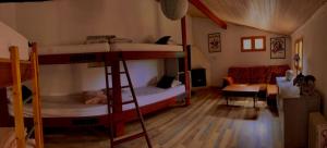 a room with two bunk beds and a couch at Mountain Hostel Finca La Isa in Tejeda