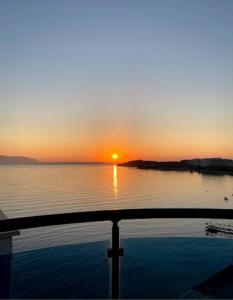 a sunset over a body of water with the sun setting at SIGNATURE BLUE RESORT in Kusadası