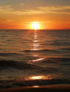 a sunset over the ocean with the sun setting at SIGNATURE BLUE RESORT in Kusadası