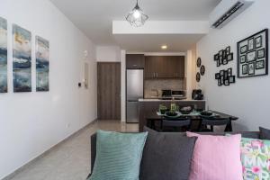 a living room with a couch and a kitchen at Aziza 1- Bedroom Apartment in Larnaca in Larnaka