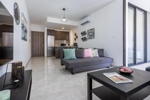 a living room with a couch and a table at Aziza 1- Bedroom Apartment in Larnaca in Larnaka