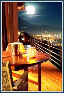 einen Tisch auf einem Balkon mit Stadtblick in der Unterkunft Atmosfera e vista mozzafiato Chalets in Aosta