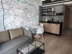 a living room with a couch and a drawing on the wall at Apartament AirPort in Wrocław