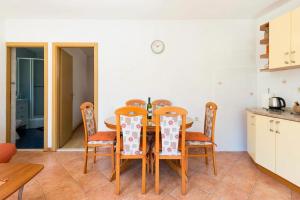 a kitchen and dining room with a table and chairs at House Marina in Rogačić