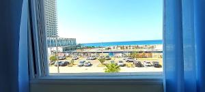 a window with a view of a parking lot at Short Term Apartment Tel Aviv Bat Yam 413 in Bat Yam