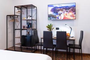 a dining room with a table and chairs and a shelf at Varese Suites in Varese