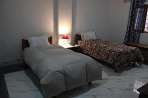 Postel nebo postele na pokoji v ubytování HOTEL BODHGAYA INN
