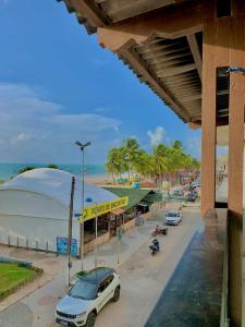 a car parked in a parking lot next to a beach at Pousada Marahub in Maragogi