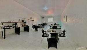 a large room with tables and chairs in it at Pousada Marahub in Maragogi