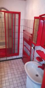 a red bathroom with a sink and a toilet at Haus Bindseil - Ferienwohnung im OG, links in Altenau