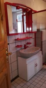 a bathroom with a sink and a mirror at Haus Bindseil - Ferienwohnung im OG, links in Altenau