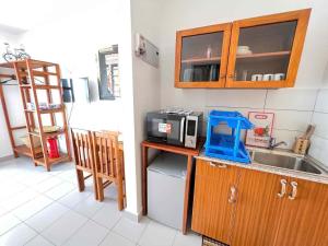 a kitchen with a sink and a microwave at Homerent @ Fumba-Town in Dambani