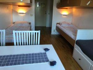 a room with two beds and a table with a solar panel at Allégården Kastlösa Vandrarhem in Kastlösa +24 photos