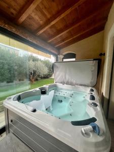 a jacuzzi tub in a room with a window at "La villa Mariam" Jacuzzi Jardin in Fourques