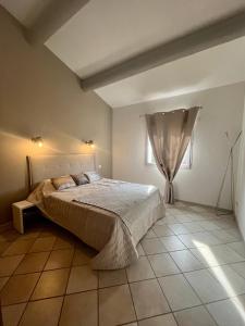 a bedroom with a large bed in a room at "La villa Mariam" Jacuzzi Jardin in Fourques