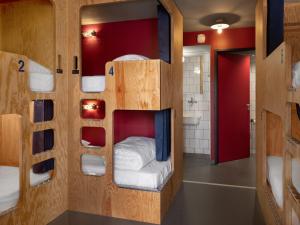 a room with bunk beds and a bathroom at Eklo Toulouse in Toulouse