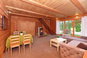 a living room with a table and a couch at Aerodream Trakai in Antakalnis