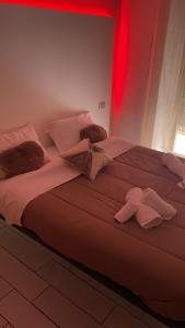 a bedroom with a large bed with red lighting at B&B Rial in Naples