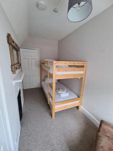 a small room with a bunk bed in a room at Pier View 2 Bedroom Apartment in Cowes