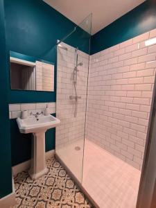 a bathroom with a sink and a shower at Pier View 2 Bedroom Apartment in Cowes