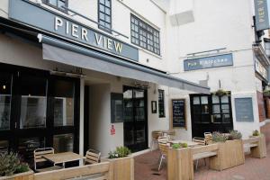 a restaurant with tables and chairs outside of a building at Pier View 2 Bedroom Apartment in Cowes