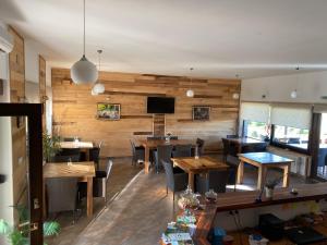 a restaurant with wooden walls and tables and chairs at Villa Stone 1 in Rakovica