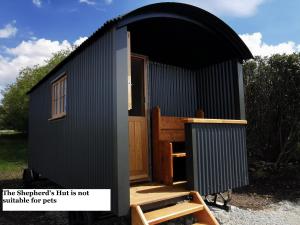 a black tiny house with a black roof at Lough Mardal Lodge in Donegal