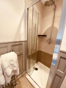a shower with a glass door in a bathroom at Self Contained Guest Suite 1 - Weymouth in Weymouth