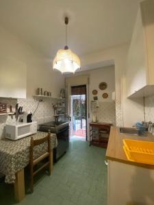 una grande cucina con tavolo e lampadario di Appartamento Leo a Paestum