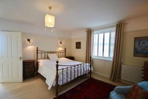 a bedroom with a bed and a large window at Albion House in Deal